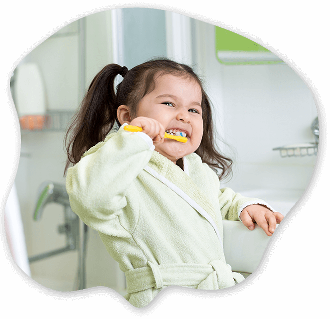 Child Brushing her Teeth at the Pediatric Dentist